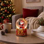 Glob de Zăpadă Premium de Crăciun cu Moș Crăciun, Bază tip Cutie Cadou cu Fundă Aurie, Muzică, Lumină LED și Efect de Ninsoare – 15 × 10 cm